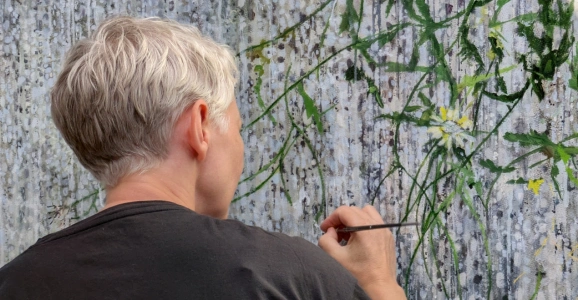 Artist Helen Thomas in her studio painting
